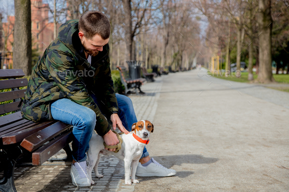 Young man with his dog, Jack Russell Terrier, - Stock Photo - Images