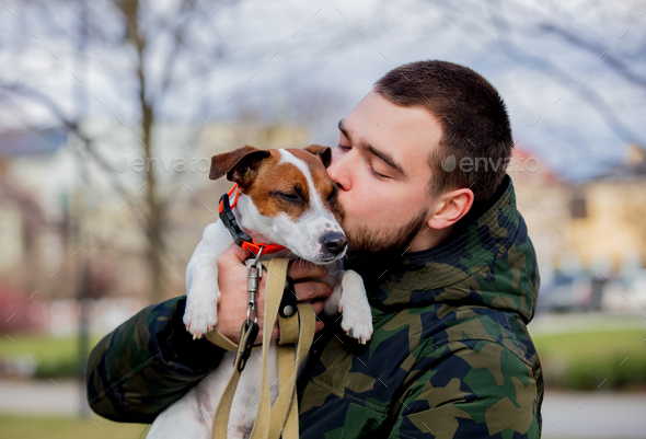 Young man with his dog, Jack Russell Terrier, - Stock Photo - Images