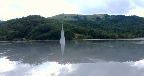 Church Spire And Cloudscape Reflection At The Toxic Lake In Geamana Village In Lupsa, Romania. aeria alt