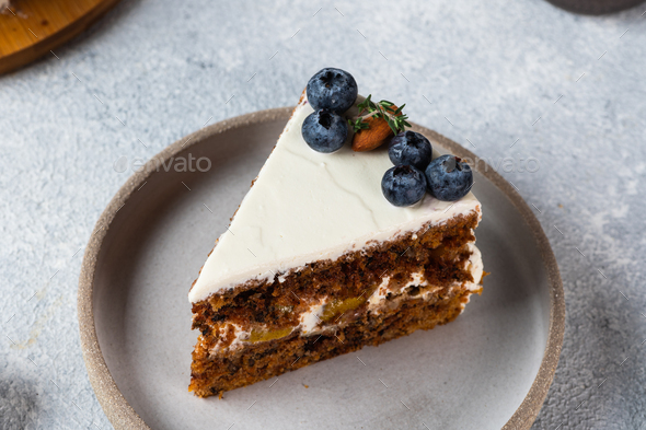 piece of carrot cake with walnuts and blueberry