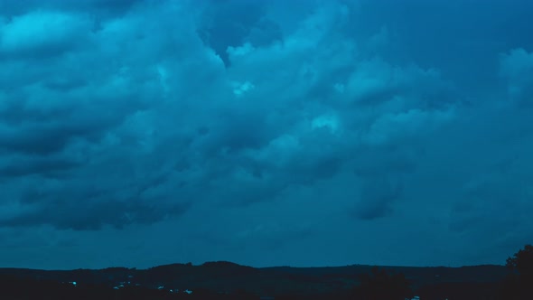 Timelapse of movement of dark blue night heavy clouds 4k footage