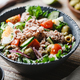 Canned tuna salad with fresh vegetables, capers and olives in a black bowl - PhotoDune Item for Sale