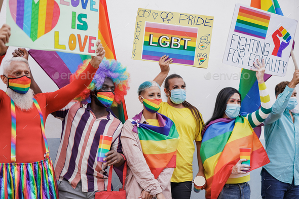 Mulitracial people holding banner at gay pride parade