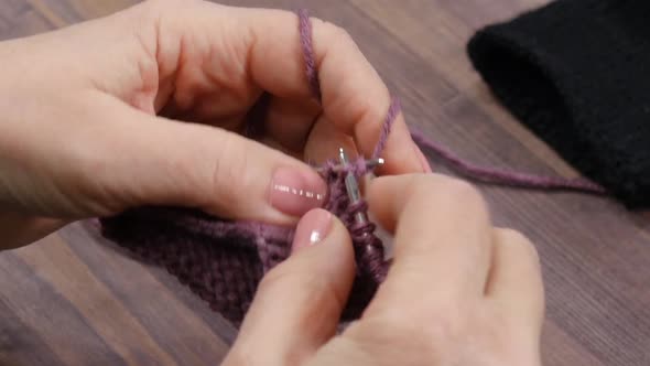 Female Hands Knitting Violet Yarn