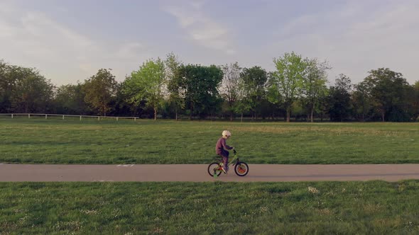 Boy On Bike with protective helmet Ride In Park
