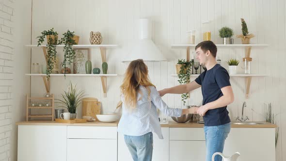 Blond Girl Guy Dance By Table Stove in Modern Kitchen alt