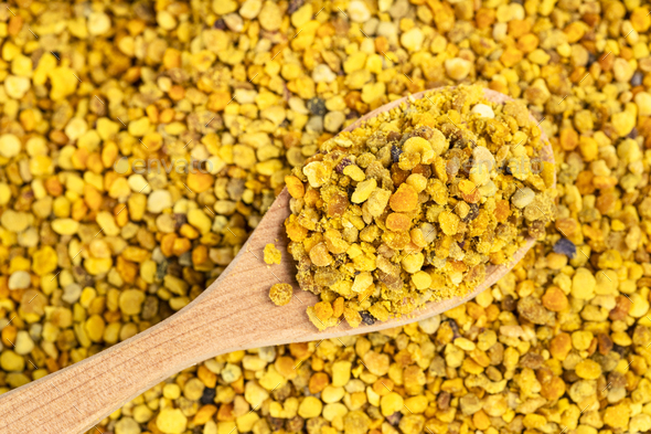 wooden spoon with natural bee pollen on bee bread