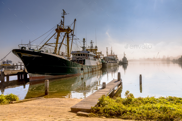 Modern fishing ships in hazy weather haringvliet - Stock Photo - Images