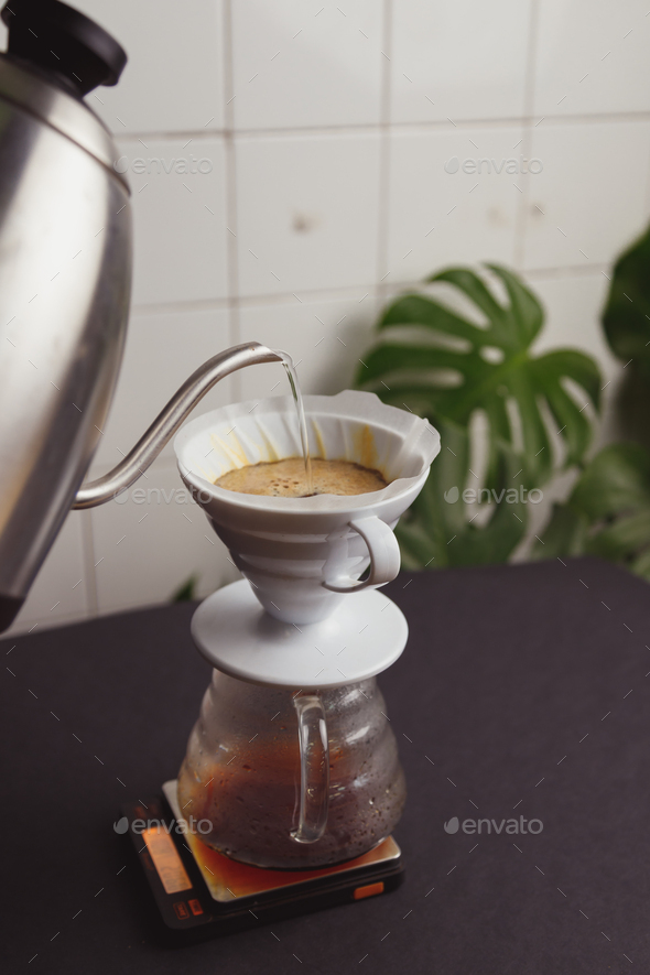 Barista pours ground coffee to aeropress Stock Photo by bublikhaus