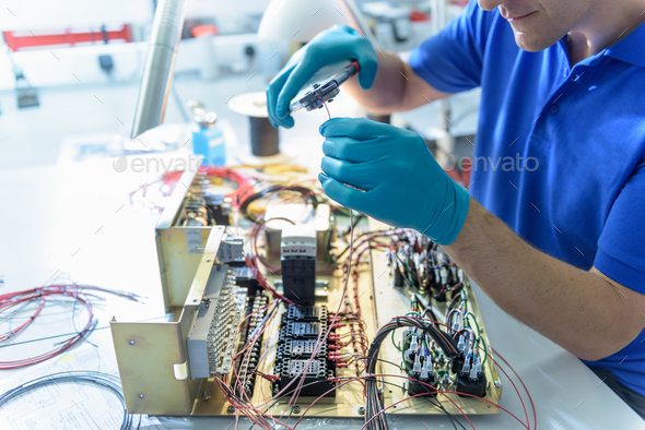 Worker assembling electronics in electronics factory - Stock Photo - Images
