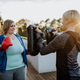 Overweight woman training boxing with personal trainer outdoors on terrace - PhotoDune Item for Sale