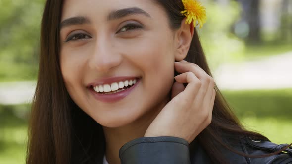Attractive Brunette Woman With Dandelion Flower In Hair Posing Outdoors alt