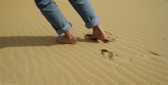 Feet Stepping on Sand Dunes