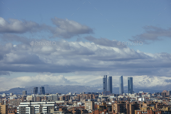 Madrid Skyline from the air, snowy in the background mountains - Stock Photo - Images