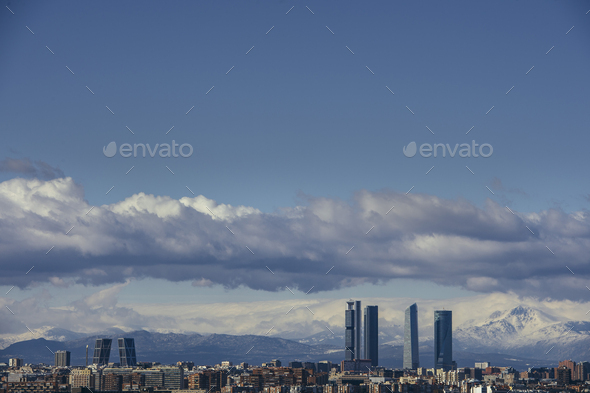Madrid Skyline from the air, snowy in the background mountains - Stock Photo - Images