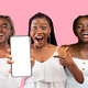 Attractive african american females showing smartphone with blank screen - PhotoDune Item for Sale