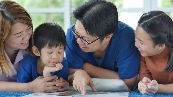 Happy Asian Family Reading Book At Home alt