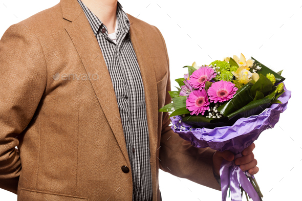 man with flowers in hand - Stock Photo - Images