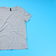 Blank gray t-shirt with space for print on blue background - PhotoDune Item for Sale