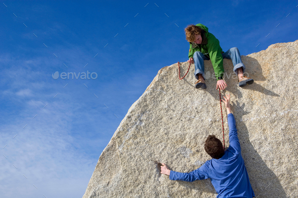 Climber helping fellow climber - Stock Photo - Images