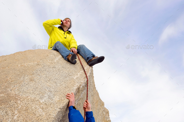 Climber belaying fellow climber - Stock Photo - Images
