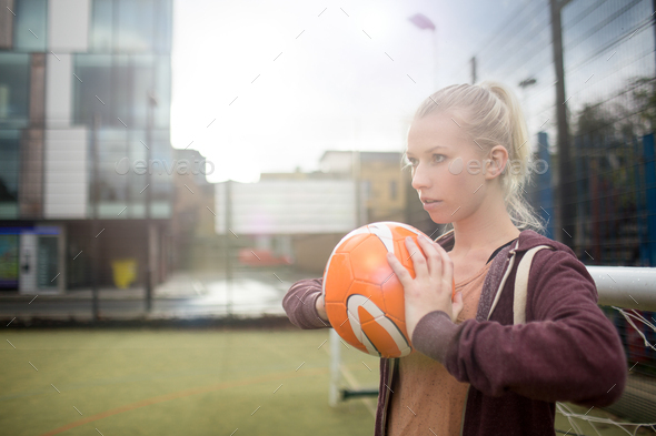 Young woman about to throw football