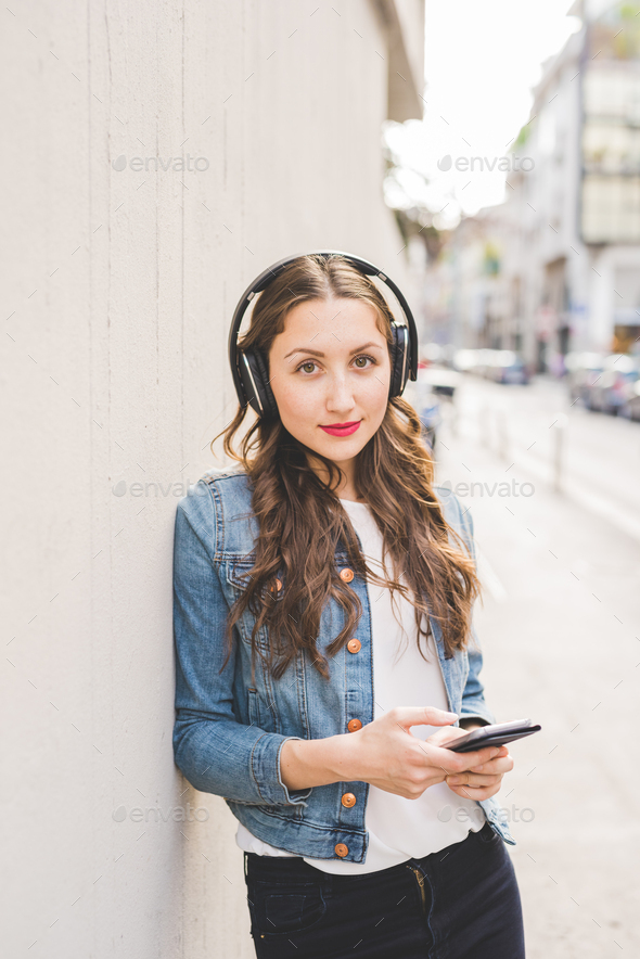 Young beautiful caucasian blonde woman listening music - Stock Photo - Images