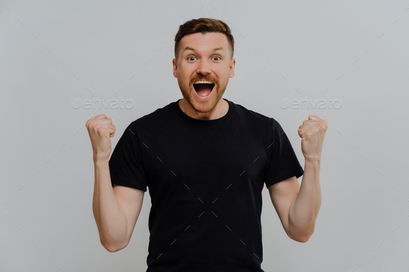 Excited happy man celebrating triumph, reaching personal goals