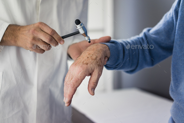 Close-up of doctor examining senior patient in medical practice