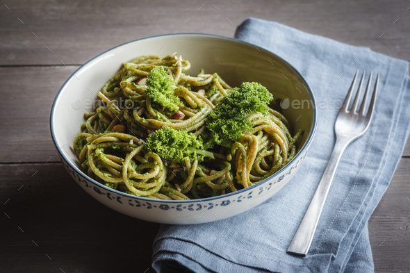 Bowl of whole-grain spelt pasta with kale and hazelnut pesto