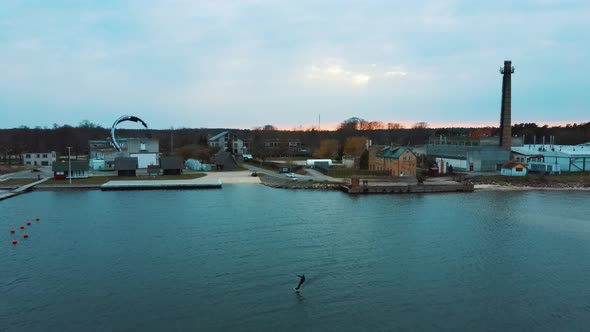 Aerial Drone View of a Corekites Kitesurfers Hydrofoiling  in Engure Port at in Baltic Sea alt