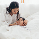 Asian mother take care and checking sick boy on bed - PhotoDune Item for Sale