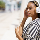 Young black woman listening to music with wireless headphones outdoors. - PhotoDune Item for Sale