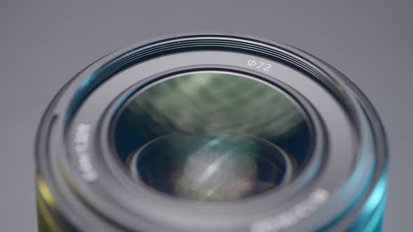 Close Up of a New Camera Lens on Blurred Grey Background alt