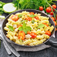 Fusilli with chicken and tomatoes in pan on black board - PhotoDune Item for Sale