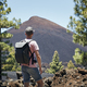 Traveler walking against volcanic landscape - PhotoDune Item for Sale