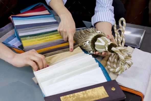 Interior designer shows samples of interior fabrics