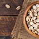 Pistachio nuts in shell  in bowl on wooden background. Top view, banner, overhead - PhotoDune Item for Sale