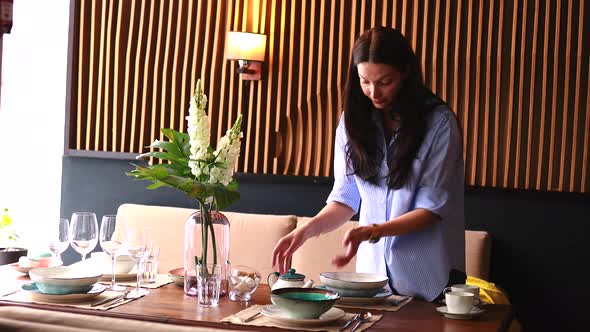 a Housewife Woman Setting a Table in Day Light Room