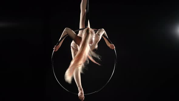 Wide Shot Aerial Gymnast in Split on Air Hoop Spinning Shaking Long Hair alt