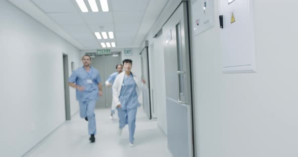 Doctors running through a hospital corridor 4k alt
