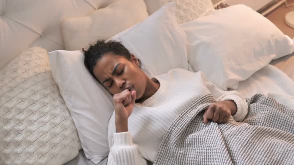 Top View of Sick Young African Girl Coughing While Sleeping in Bed alt