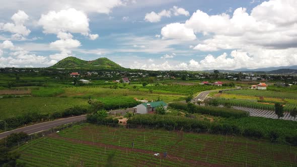 Cinematic Aerial View of Vietnam Countryside with View of Green Farms and Village. alt