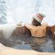 Woman relaxing in hot bath at snowy mountains - PhotoDune Item for Sale