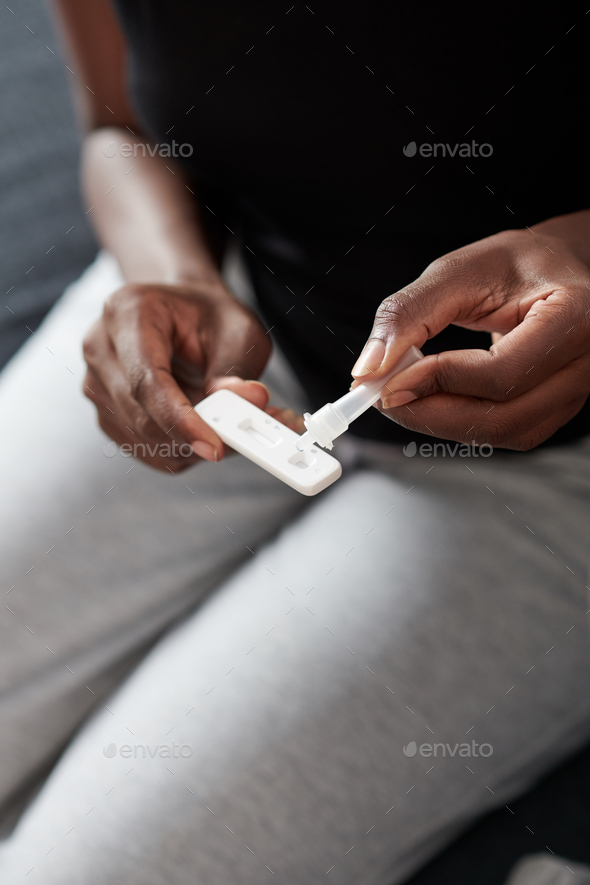 Woman Putting Saliva in Test Cassette