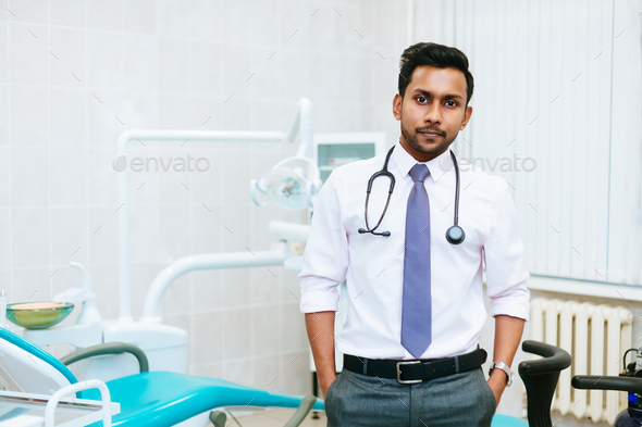 Portrait of a young confident asian male dentist in clinic. Dental clinic concept