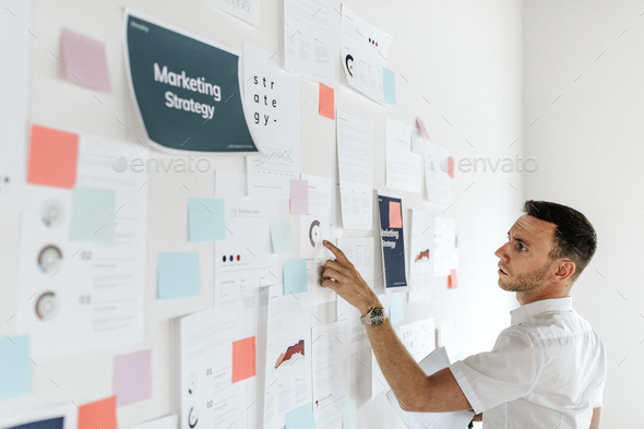 A casual business man checking a marketing plan - Stock Photo - Images