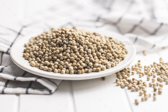 Whole pepper spice. White peppercorn grain on plate - Stock Photo - Images