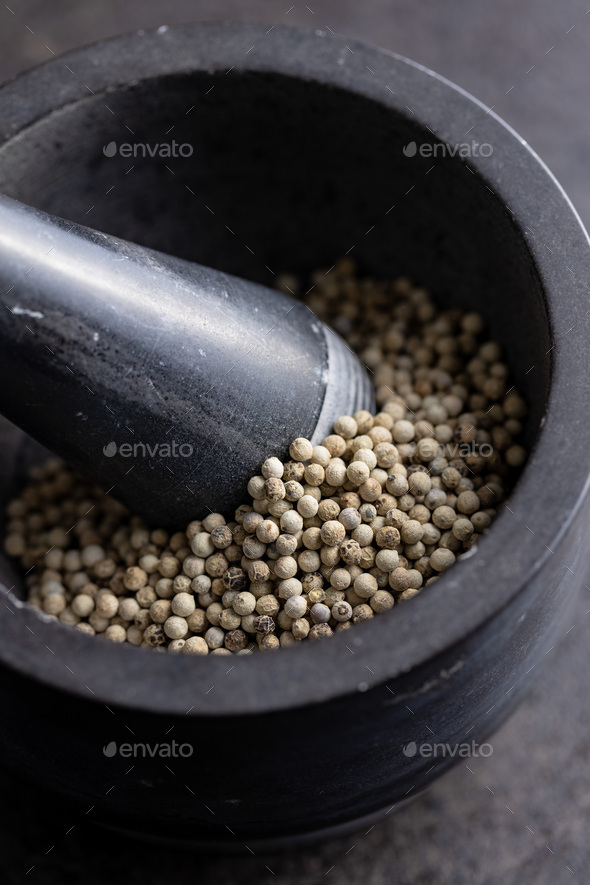 Whole pepper spice. White peppercorn grain in mortar - Stock Photo - Images