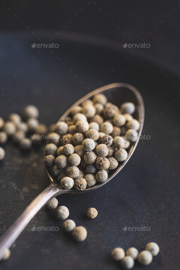 Whole pepper spice. White peppercorn grain in spoon - Stock Photo - Images